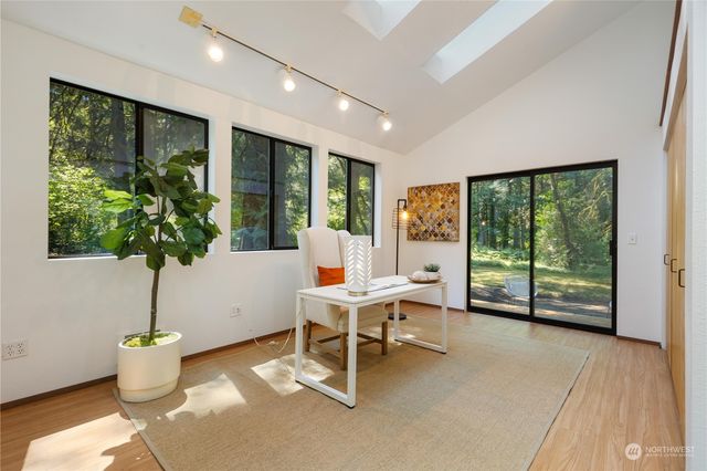 a living room with a large window and dining table