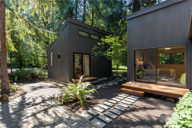a backyard of a house with fountain and outdoor seating