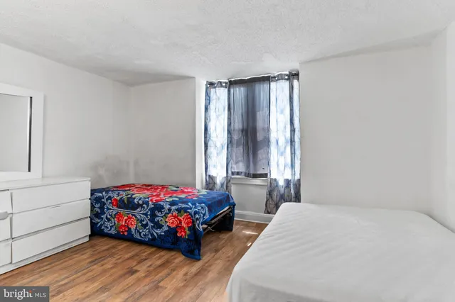 a bedroom with bed and window