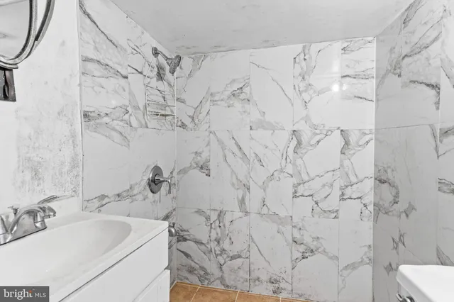 a bathroom with shower sink and toilet