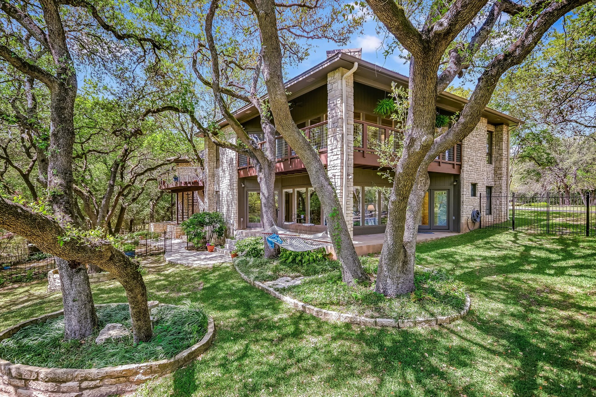 3901 Prentice Lane Austin, TX 78746 - Photo 27 of 40 Mature live oaks provide shade and enhance the private atmosphere of the backyard.
