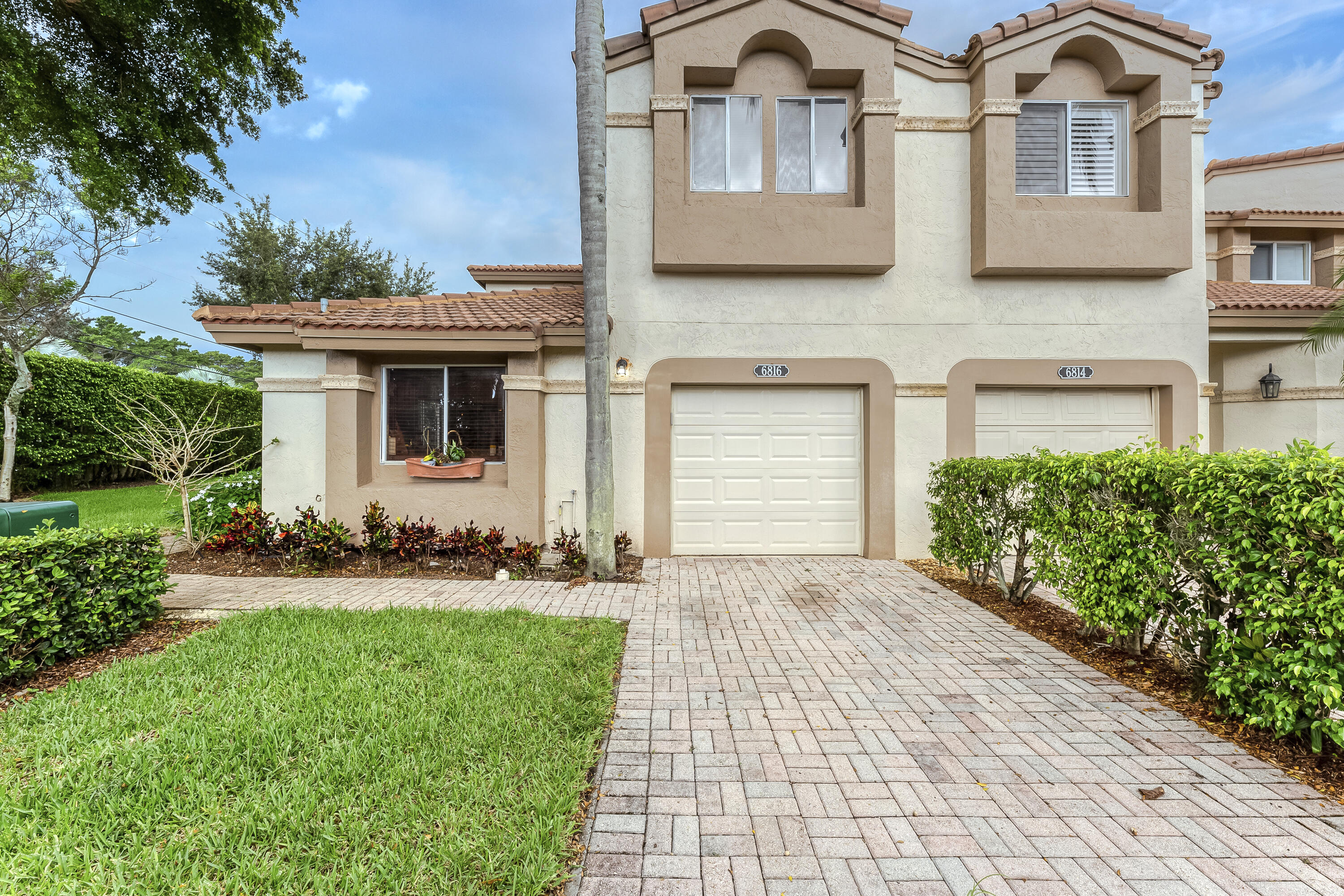 6816 Via Regina Boca Raton, FL 33433 - Photo 2 of 36 a front view of a house with garden