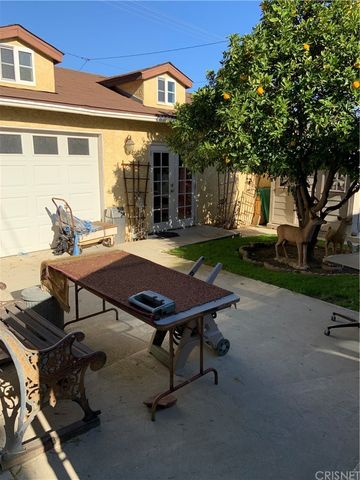 a backyard of a house with yard fire pit barbeque oven and outdoor seating