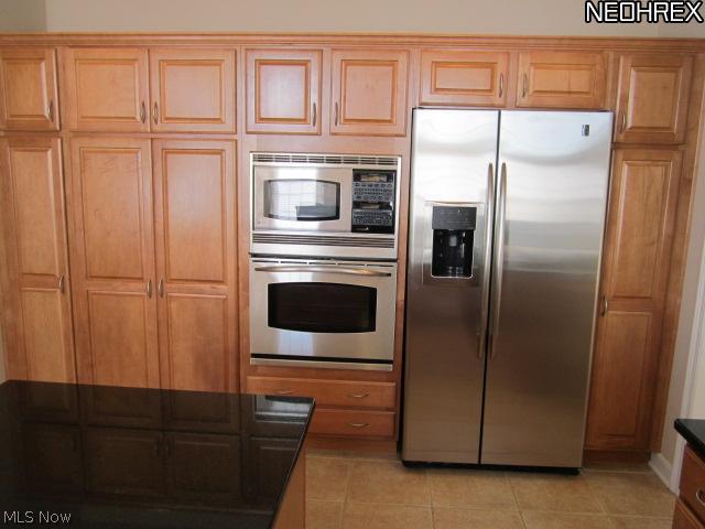 180 Burwick Road, Unit A118 Cleveland, OH 44143 - Photo 6 of 14 Wall of Merillat cabinetry with sliding shelves and soft close drawers. Side by side stainless steel fridge and built in microwave and convection oven.
