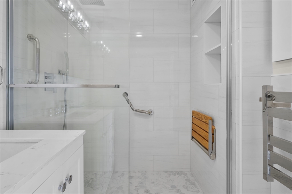 151 Tremont Street, Unit 18M Boston, MA 02111 - Photo 18 of 35 a bathroom with a sink a vanity and a shower