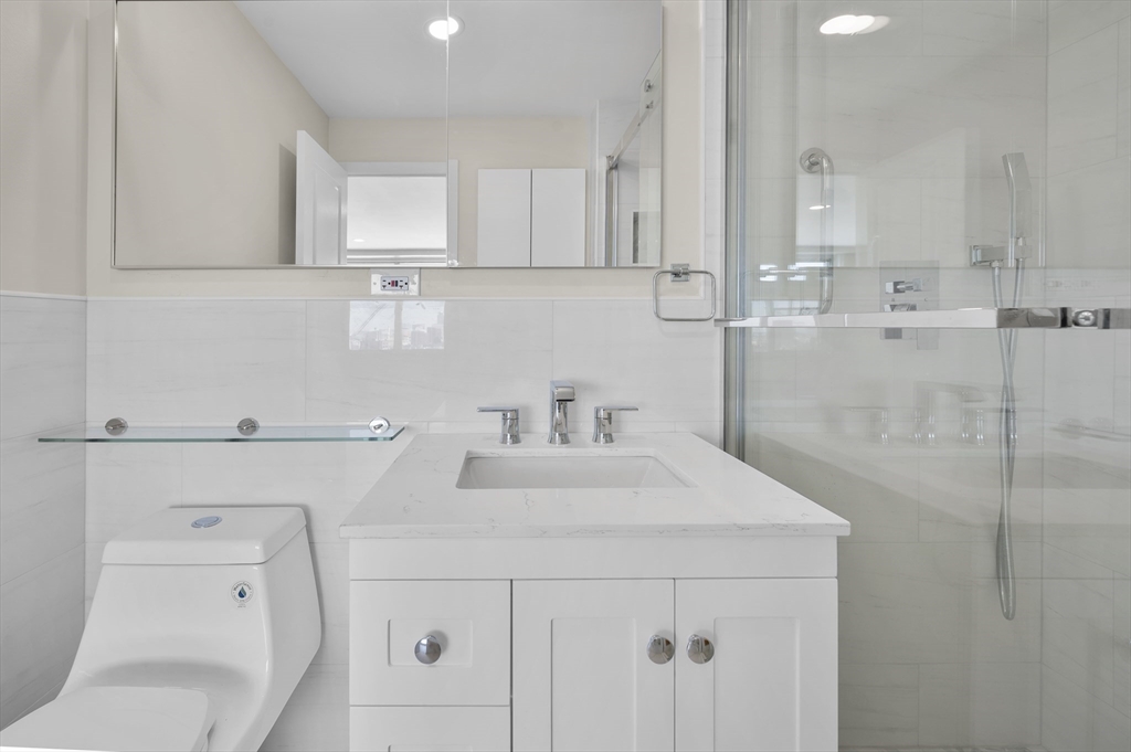 151 Tremont Street, Unit 18M Boston, MA 02111 - Photo 19 of 35 a kitchen with a sink cabinets and toilet