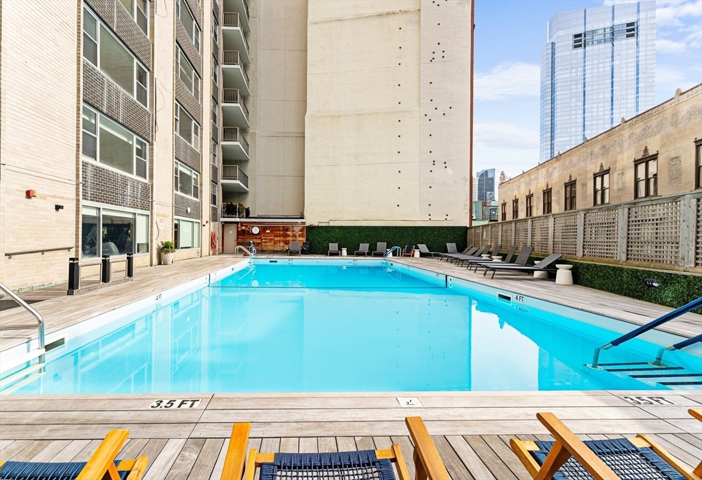 151 Tremont Street, Unit 18M Boston, MA 02111 - Photo 27 of 35 a view of a swimming pool with a lounge chairs