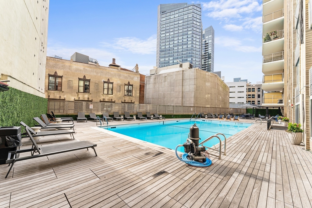 151 Tremont Street, Unit 18M Boston, MA 02111 - Photo 28 of 35 a view of a swimming pool with a lounge chairs
