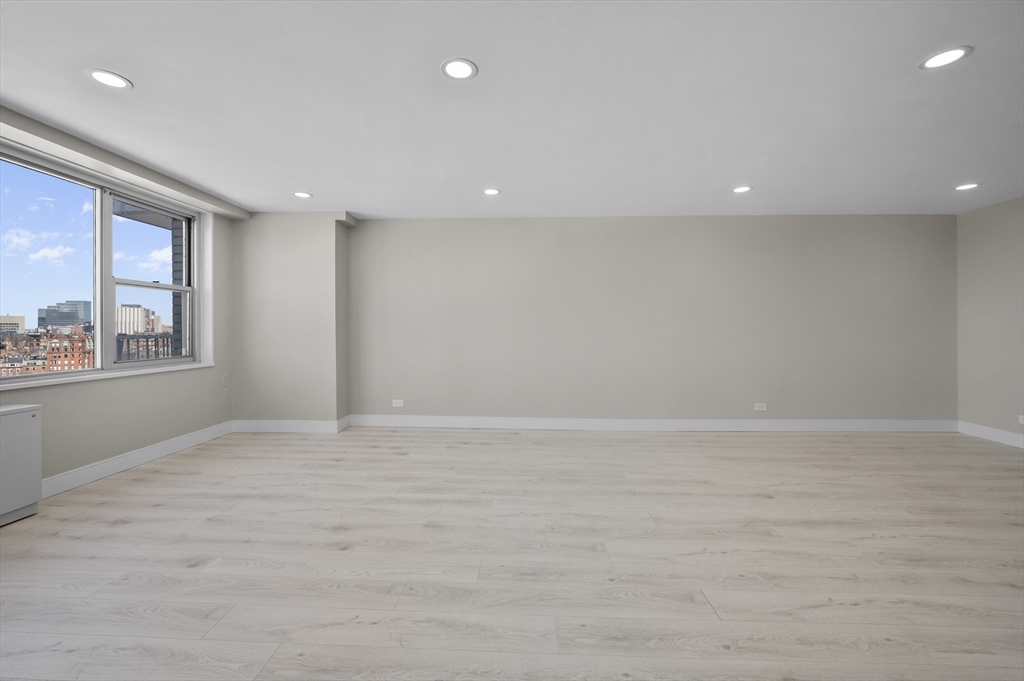 151 Tremont Street, Unit 18M Boston, MA 02111 - Photo 7 of 35 an empty room with windows
