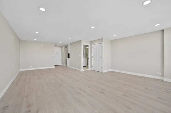 a kitchen with stainless steel appliances granite countertop white cabinets and a sink