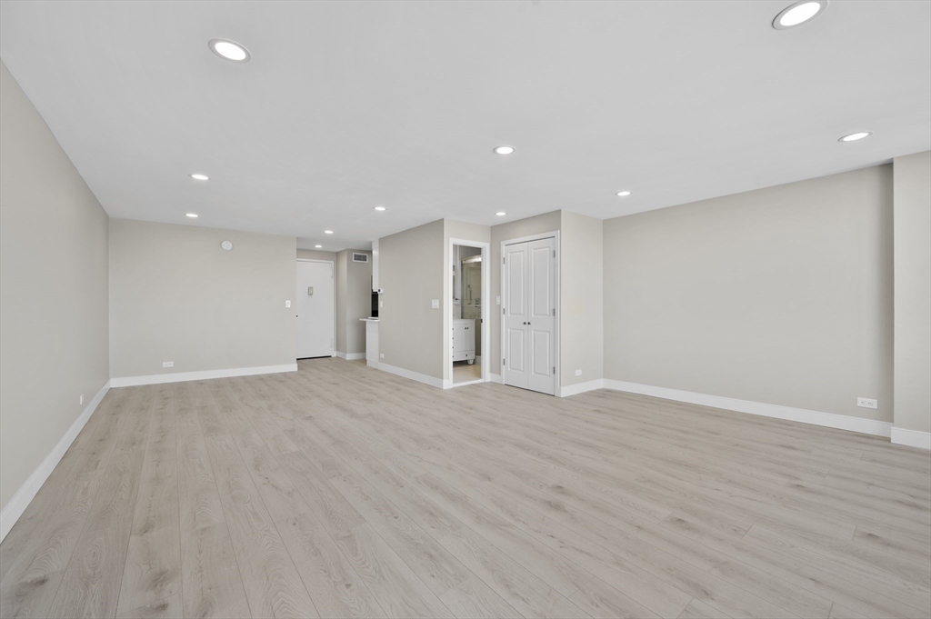 151 Tremont Street, Unit 18M Boston, MA 02111 - Photo 10 of 35 a view of an empty room with wooden floor
