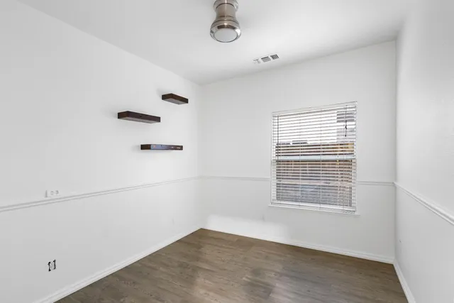 a view of a room with rack on the wall and a window