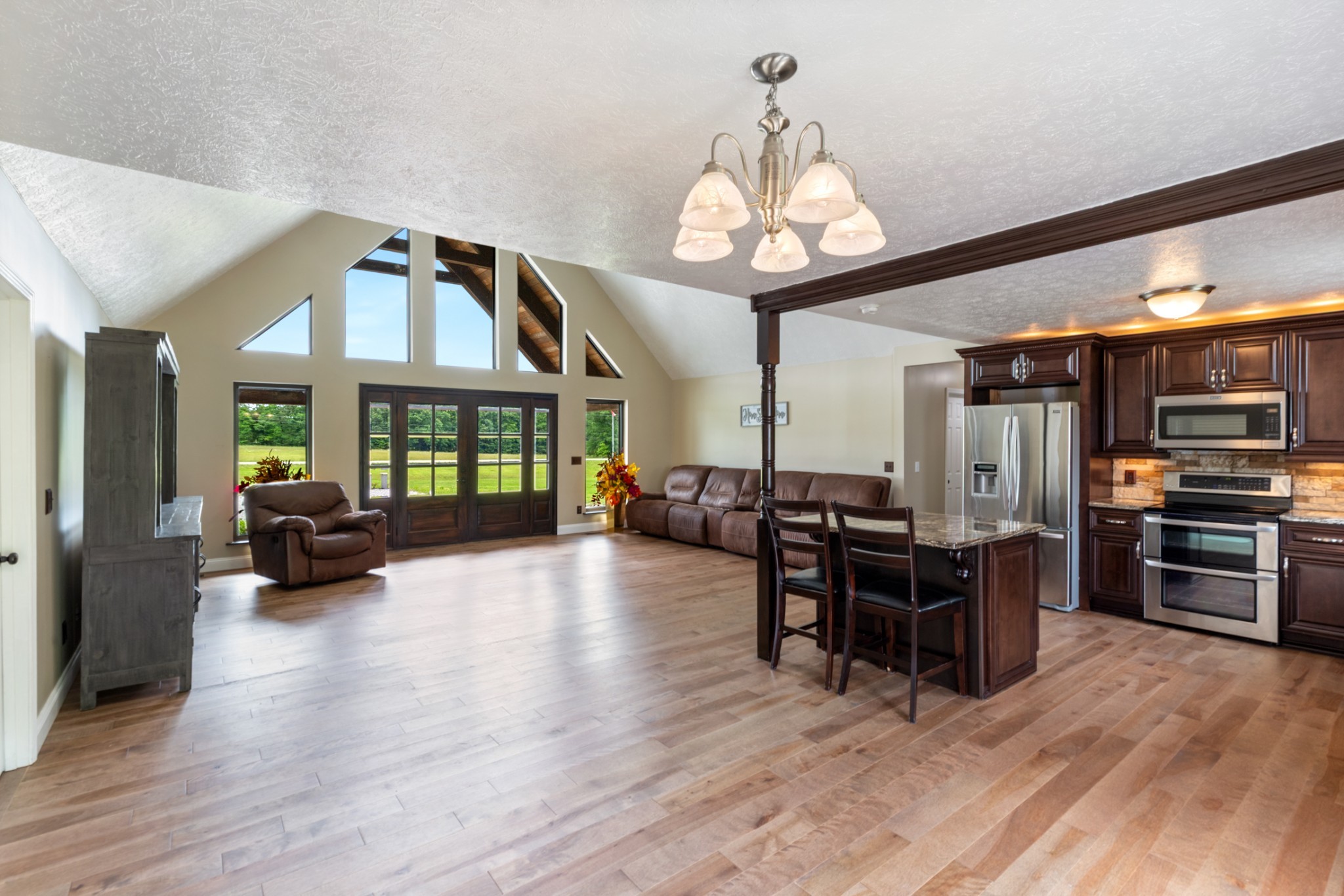3791 Sylvia Road Dickson, TN 37055 - Photo 17 of 82 a view of a dining room with furniture a chandelier and wooden floor