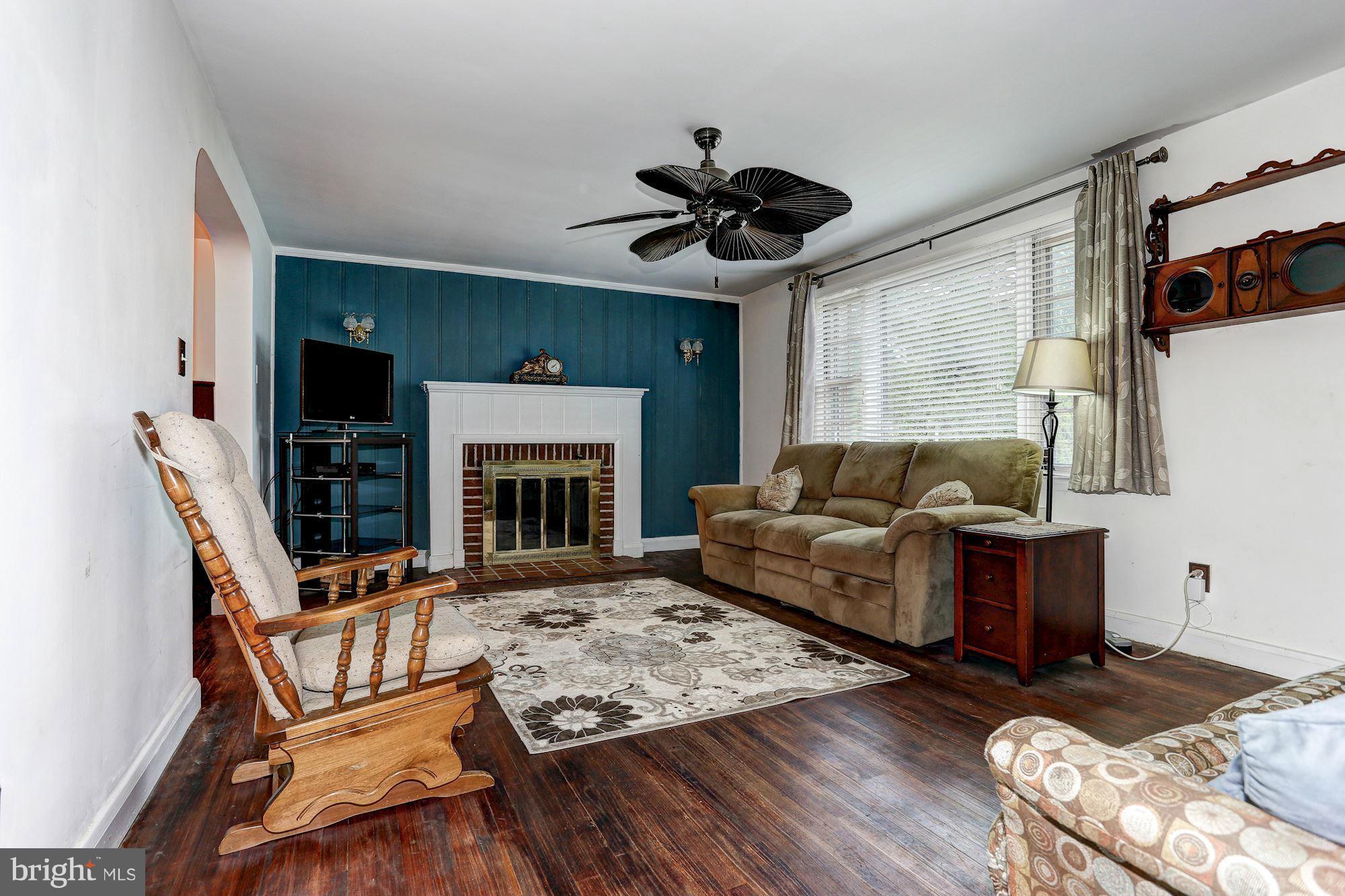 402 North Rolling Road Catonsville, MD 21228 - Photo 2 of 17 a living room with furniture and a fireplace