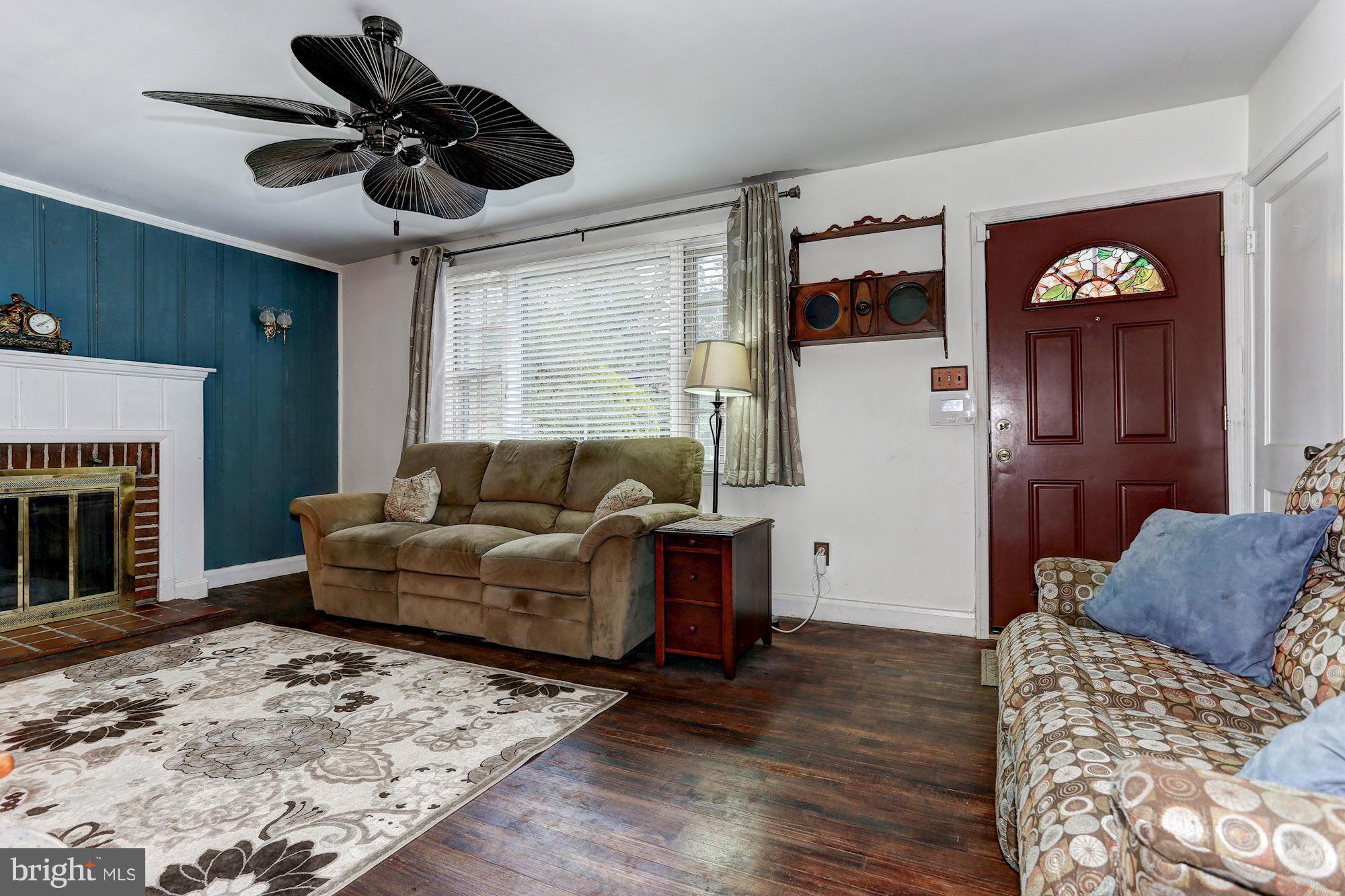 402 North Rolling Road Catonsville, MD 21228 - Photo 3 of 17 a living room with furniture and a fireplace