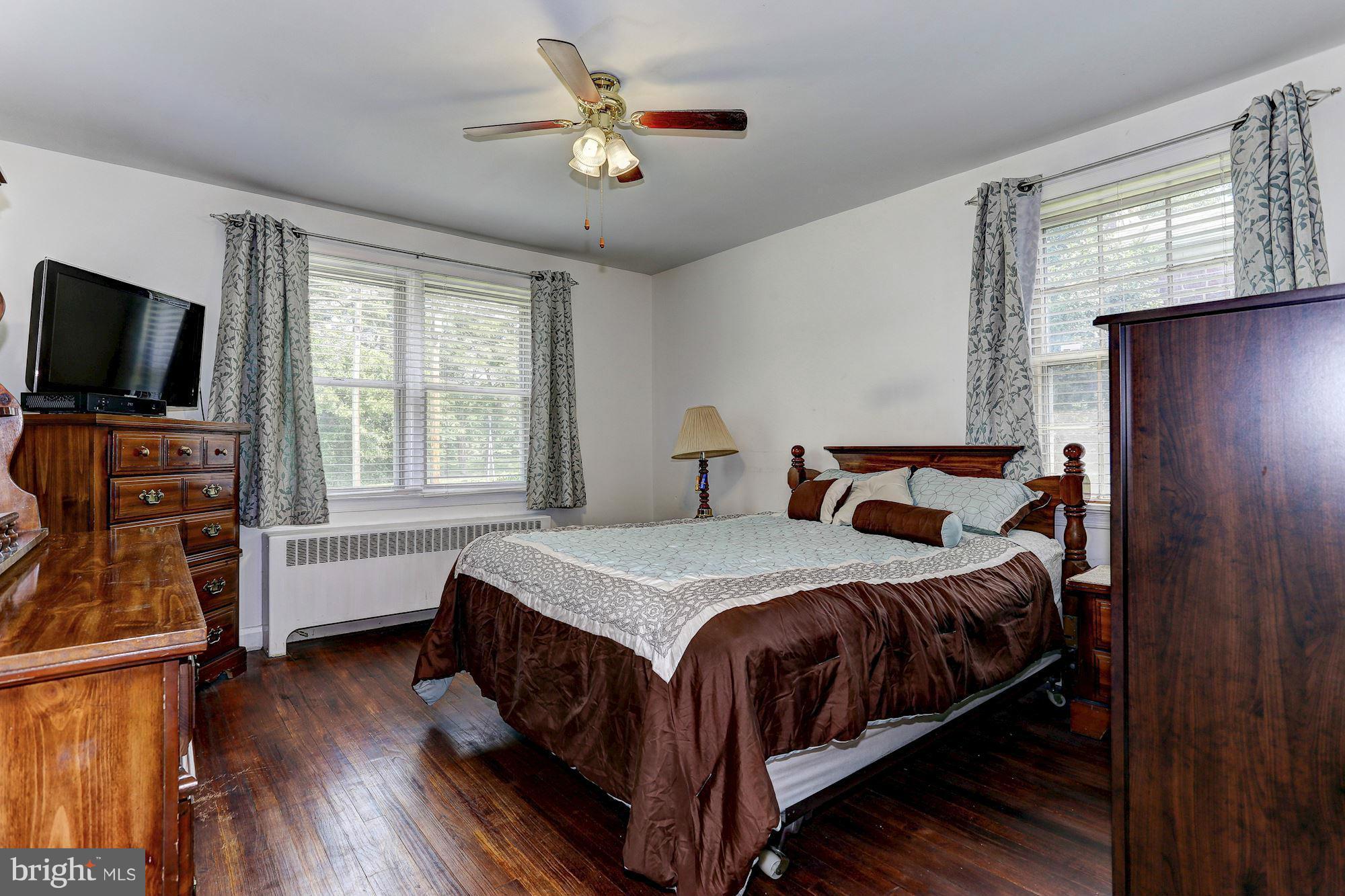 402 North Rolling Road Catonsville, MD 21228 - Photo 8 of 17 a bedroom with a bed and a flat screen tv