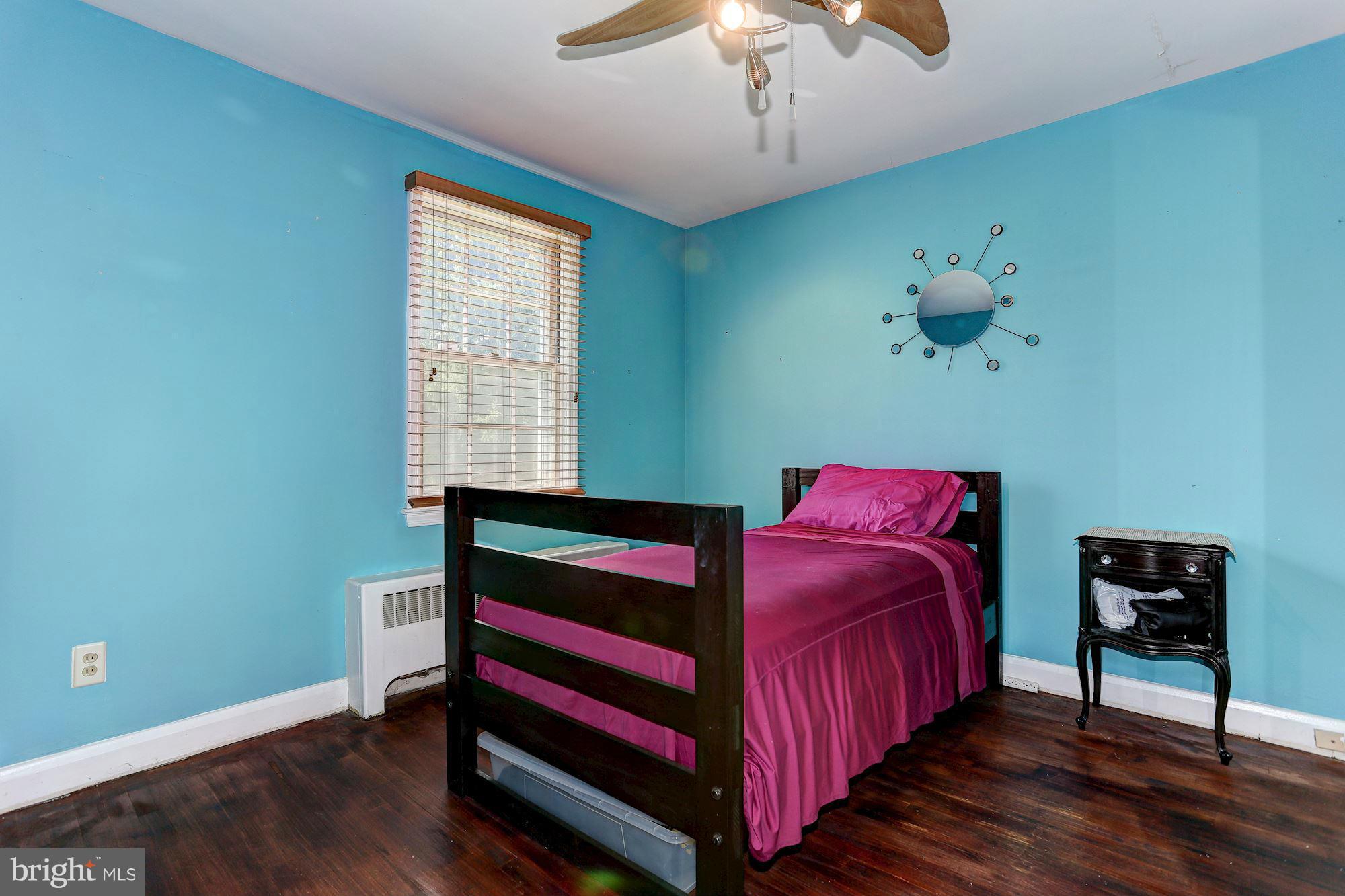 402 North Rolling Road Catonsville, MD 21228 - Photo 9 of 17 a bedroom with a bed and a chandelier