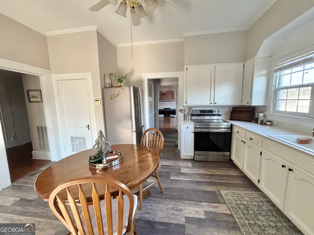 a kitchen with a stove a sink and a dining table