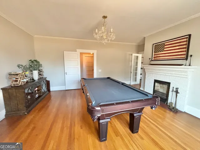 a room with pool table and windows