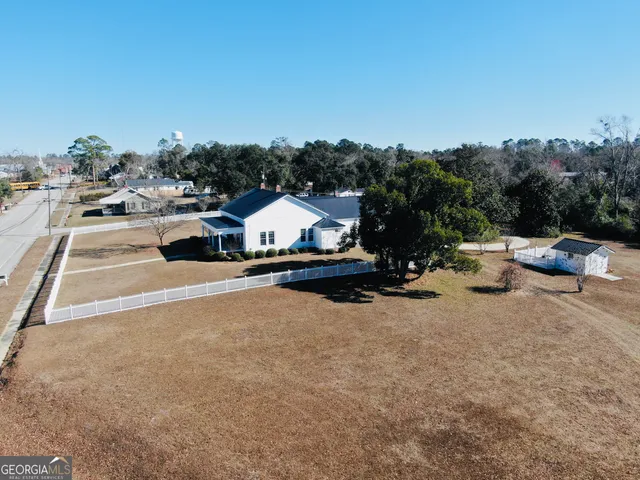 an aerial view of a house with a yard basket ball court and outdoor seating
