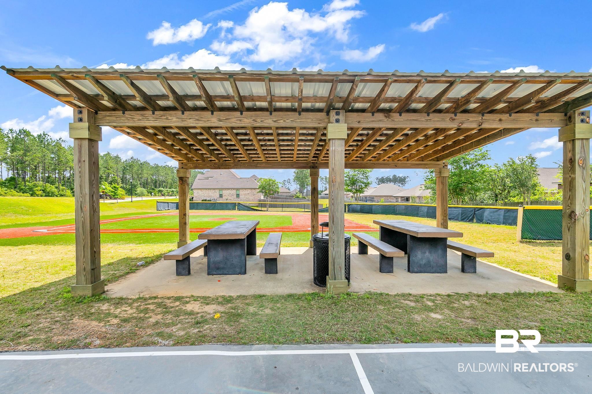 13233 Ibis Boulevard Daphne, AL 36527 - Photo 91 of 100 Wood pergola with a metal roof covering a concrete pad