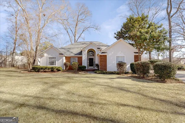a front view of a house with a garden