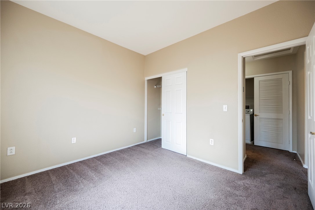 6320 Snap Ridge Street, Unit 201 North Las Vegas, NV 89081 - Photo 11 of 56 A well-lit room offers soft carpeting and a convenient sliding closet door.