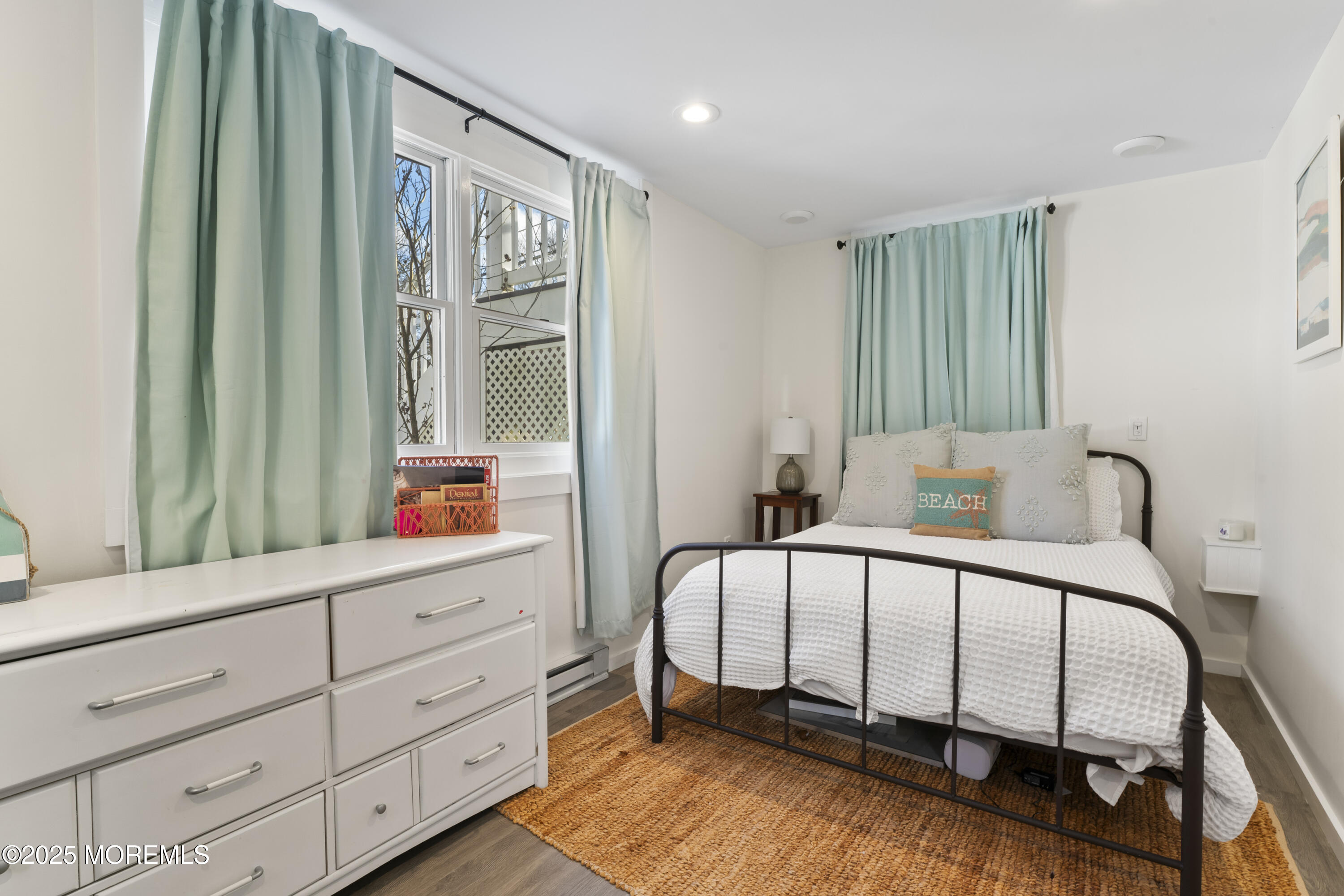 90 River Road Rumson, NJ 07760 - Photo 24 of 32 a bedroom with a bed and a mirror on the dresser