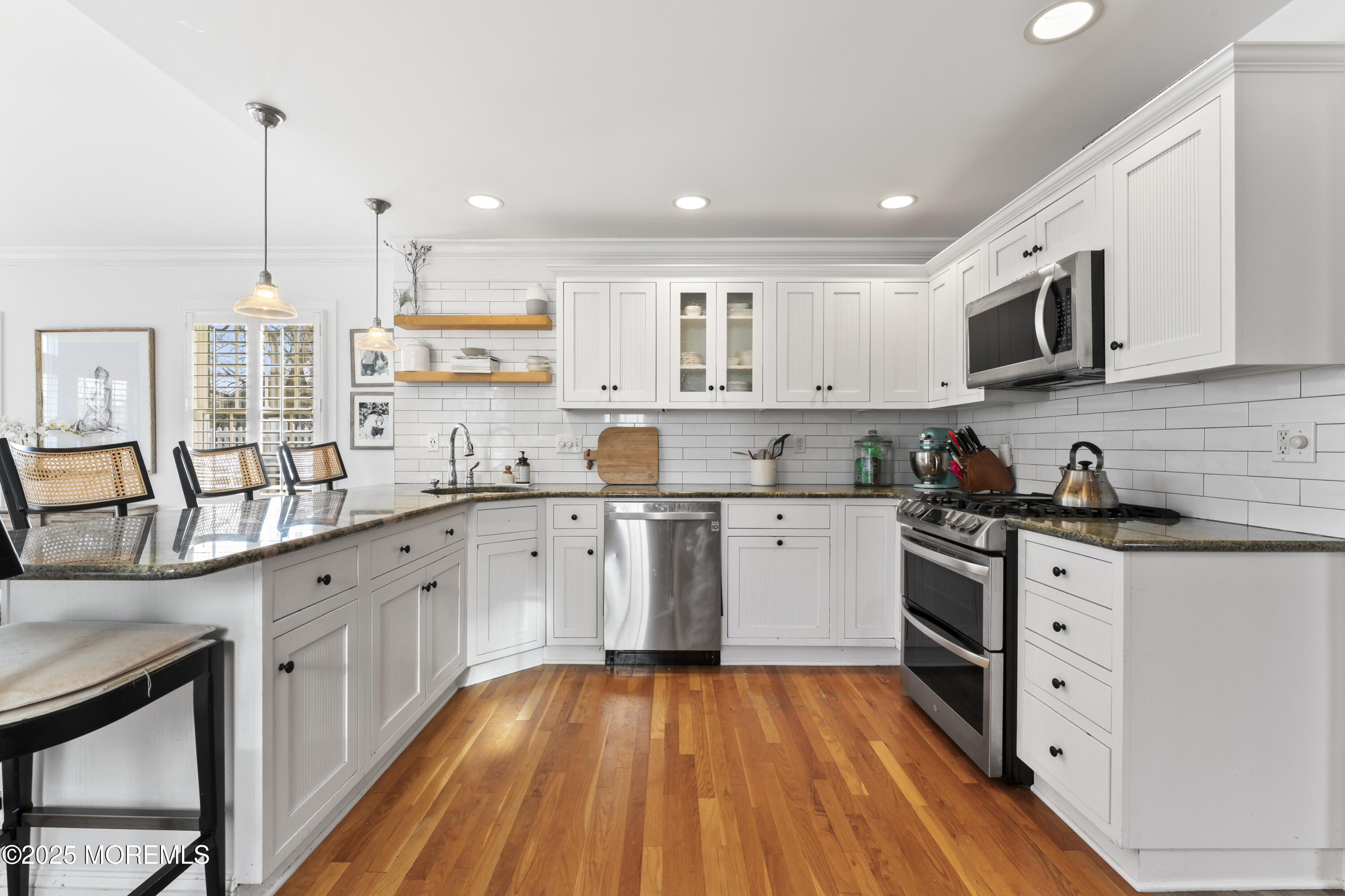 90 River Road Rumson, NJ 07760 - Photo 4 of 32 a kitchen with stainless steel appliances kitchen island granite countertop a sink cabinets and wooden floor
