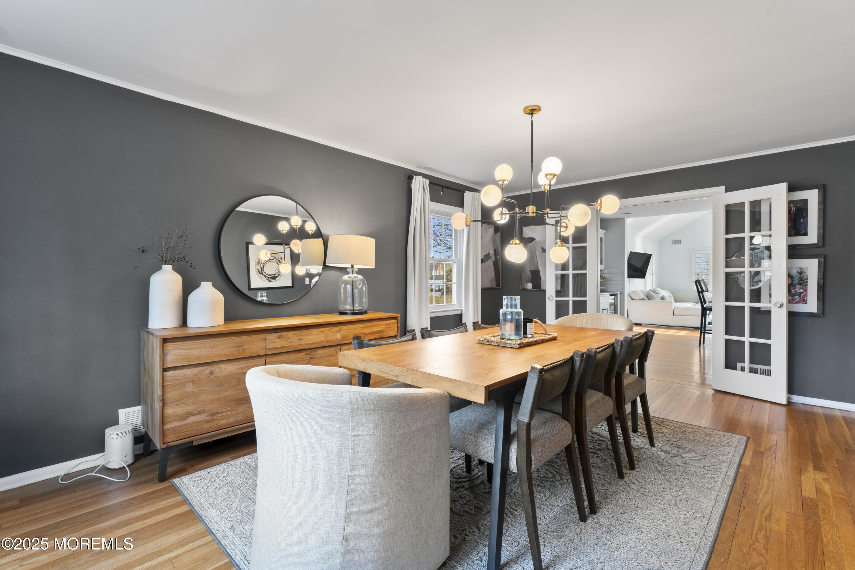 90 River Road Rumson, NJ 07760 - Photo 10 of 32 a dining room with chandelier and wooden floor
