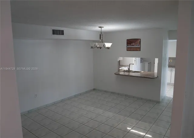 a kitchen with cabinets and a wooden floor