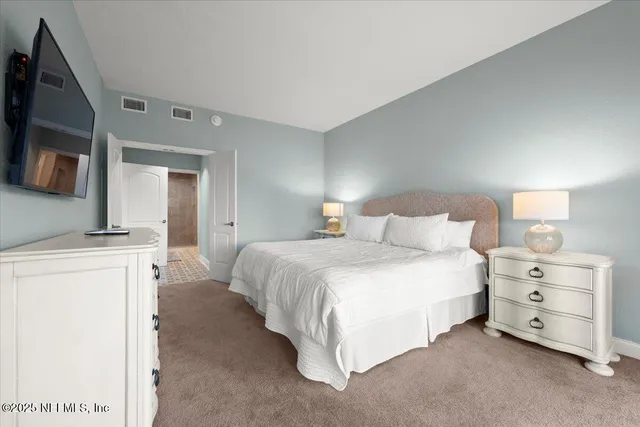 a bedroom with a bed and a lamp