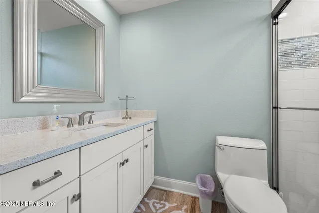 a front view of a house with a yard and potted plants