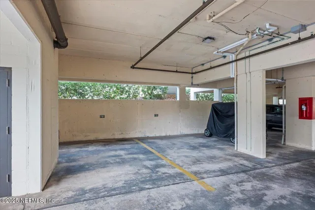 a view of a patio with table and chairs potted plants and palm tree