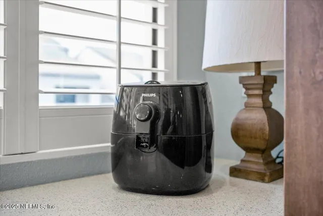 a dining room with wooden floor a chandelier a wooden table and chairs