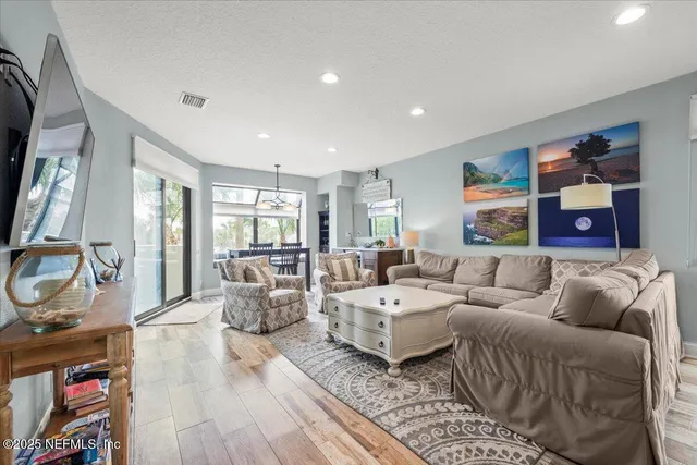 a view of cabinets a sink and a refrigerator in a kitchen