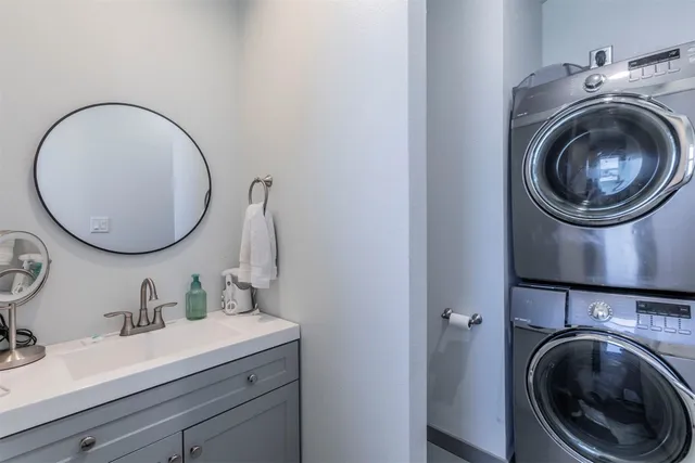 a bathroom with a sink mirror and vanity