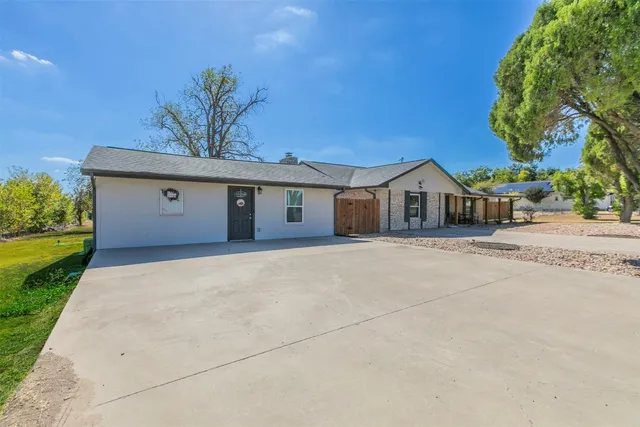 a front view of a house with a garden and yard