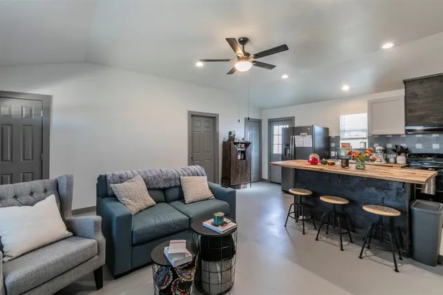 a living room with furniture and kitchen view