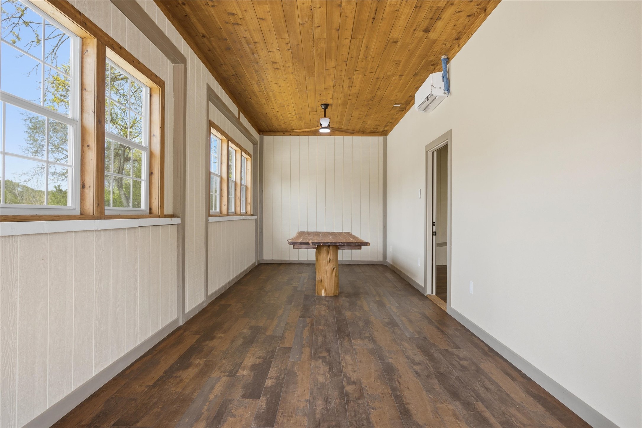 Undisclosed Address Buda, TX 78610 - Photo 12 of 19 a view of a hallway with wooden floor and a window