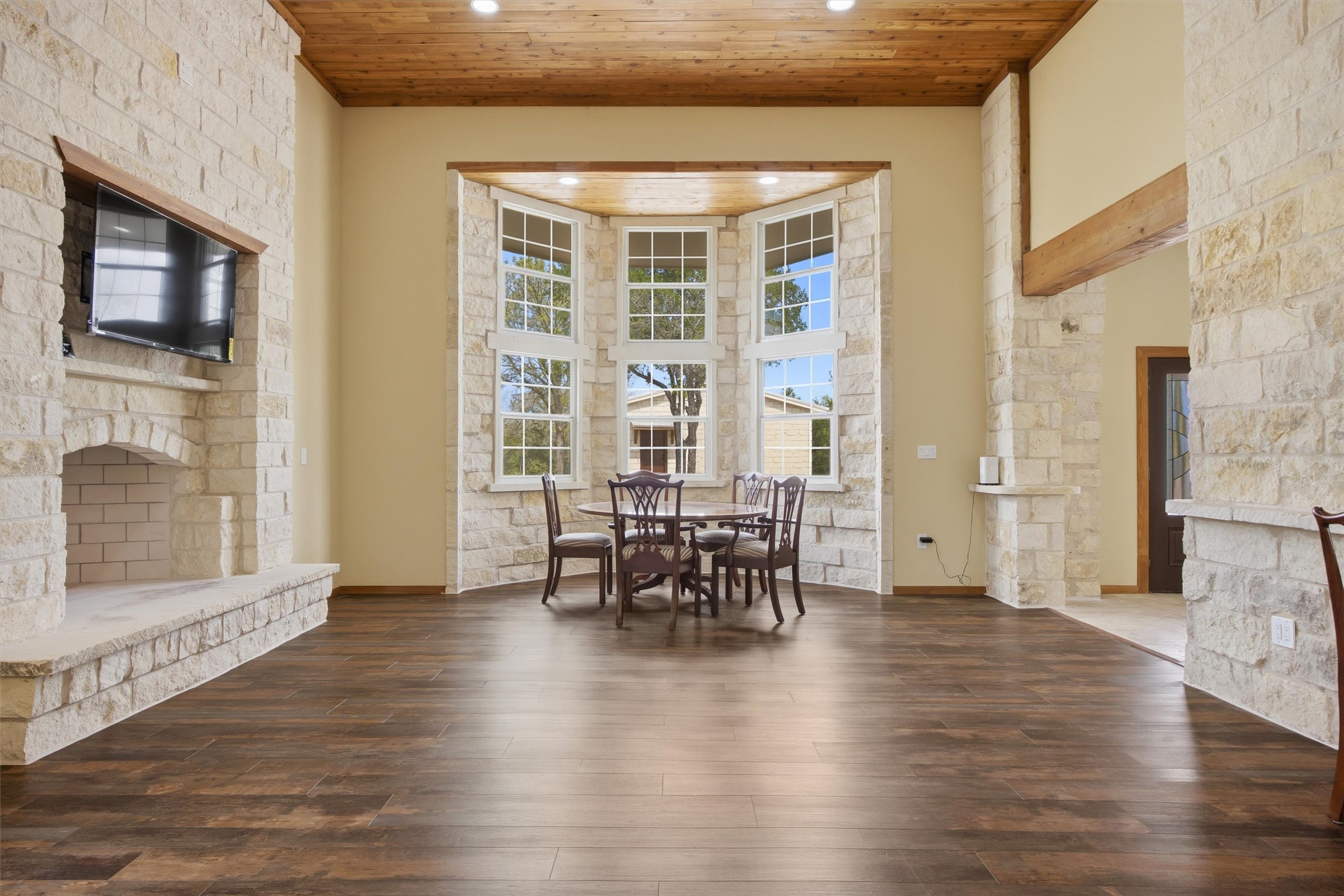 Undisclosed Address Buda, TX 78610 - Photo 2 of 19 a dining room with furniture and wooden floor a chandelier