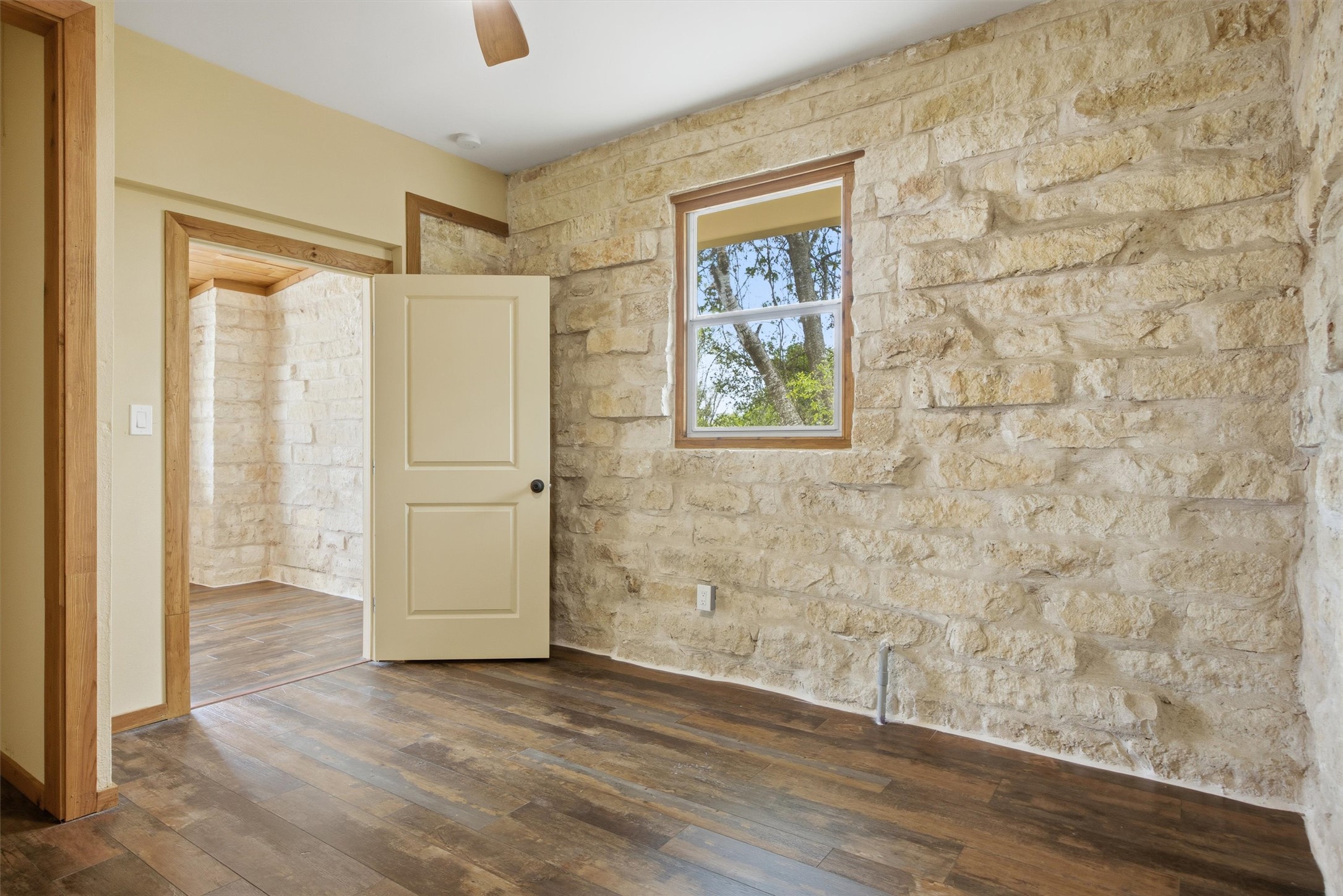 Undisclosed Address Buda, TX 78610 - Photo 8 of 19 an empty room with wooden floor and window