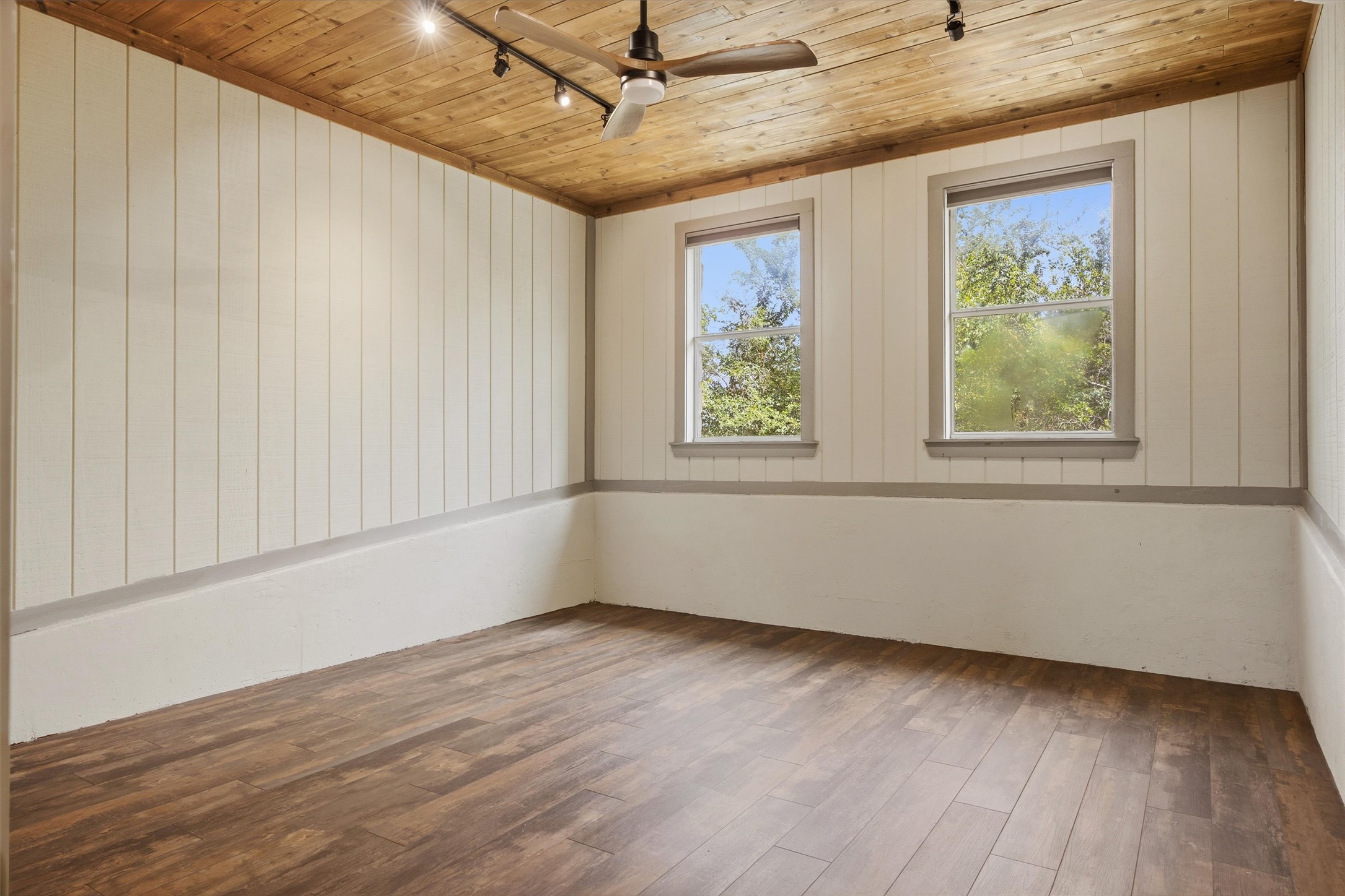 Undisclosed Address Buda, TX 78610 - Photo 10 of 19 an empty room with wooden floor and windows