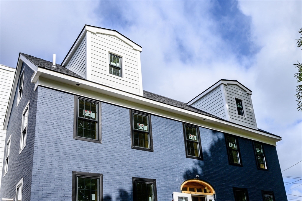 29 R Ashland Street, Unit 29R Boston, MA 02122 - Photo 10 of 22 a front view of a building with parking space