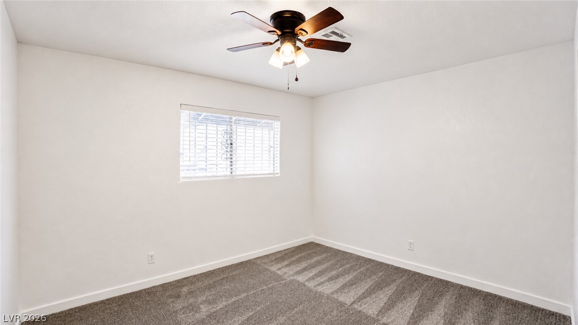 2870 South Sandhill Road Las Vegas, NV 89121 - Photo 44 of 64 A versatile room with ample space features a ceiling fan and a window for natural light.