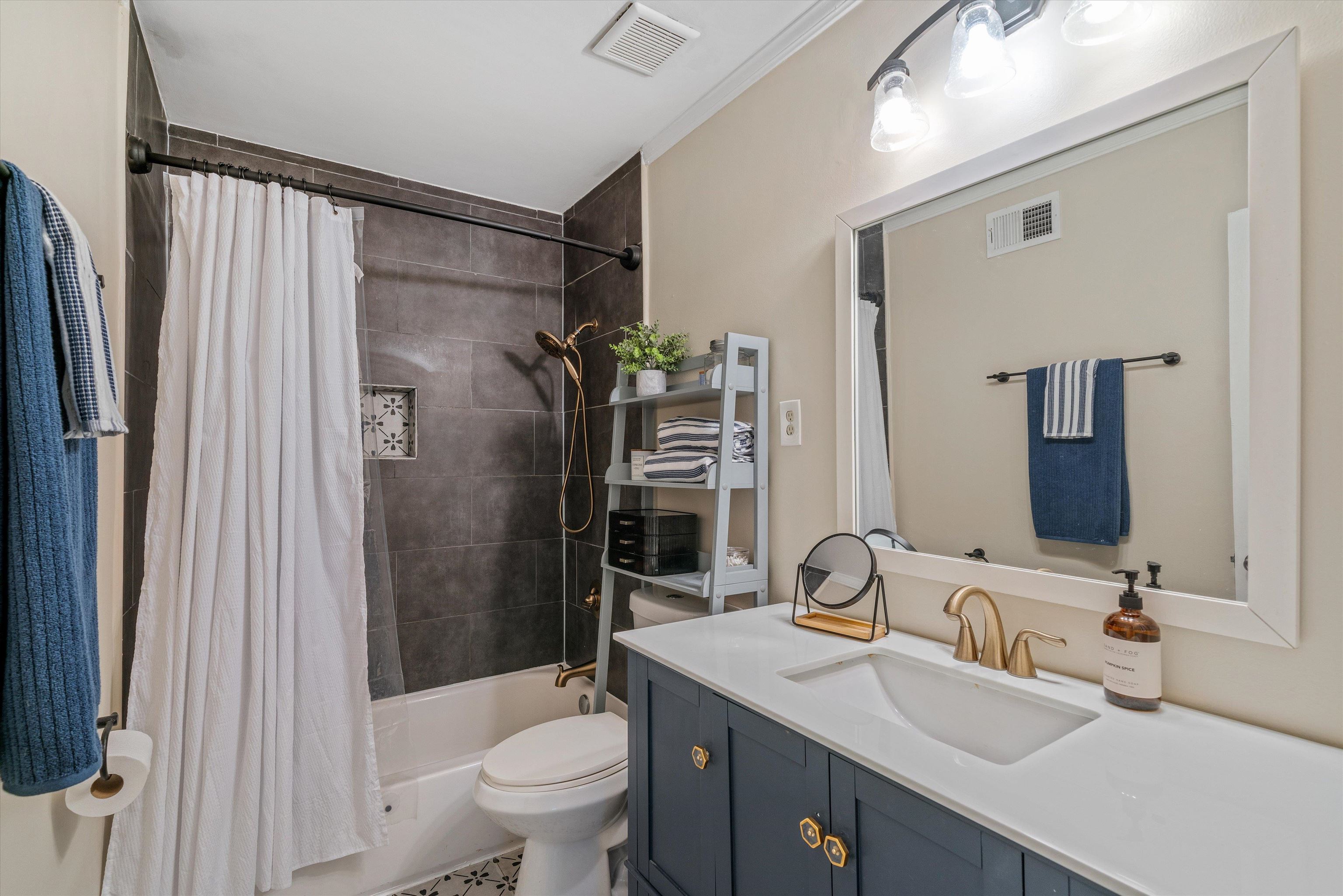 1064 Wilbec Road Memphis, TN 38117 - Photo 16 of 23 a bathroom with a granite countertop sink toilet and shower