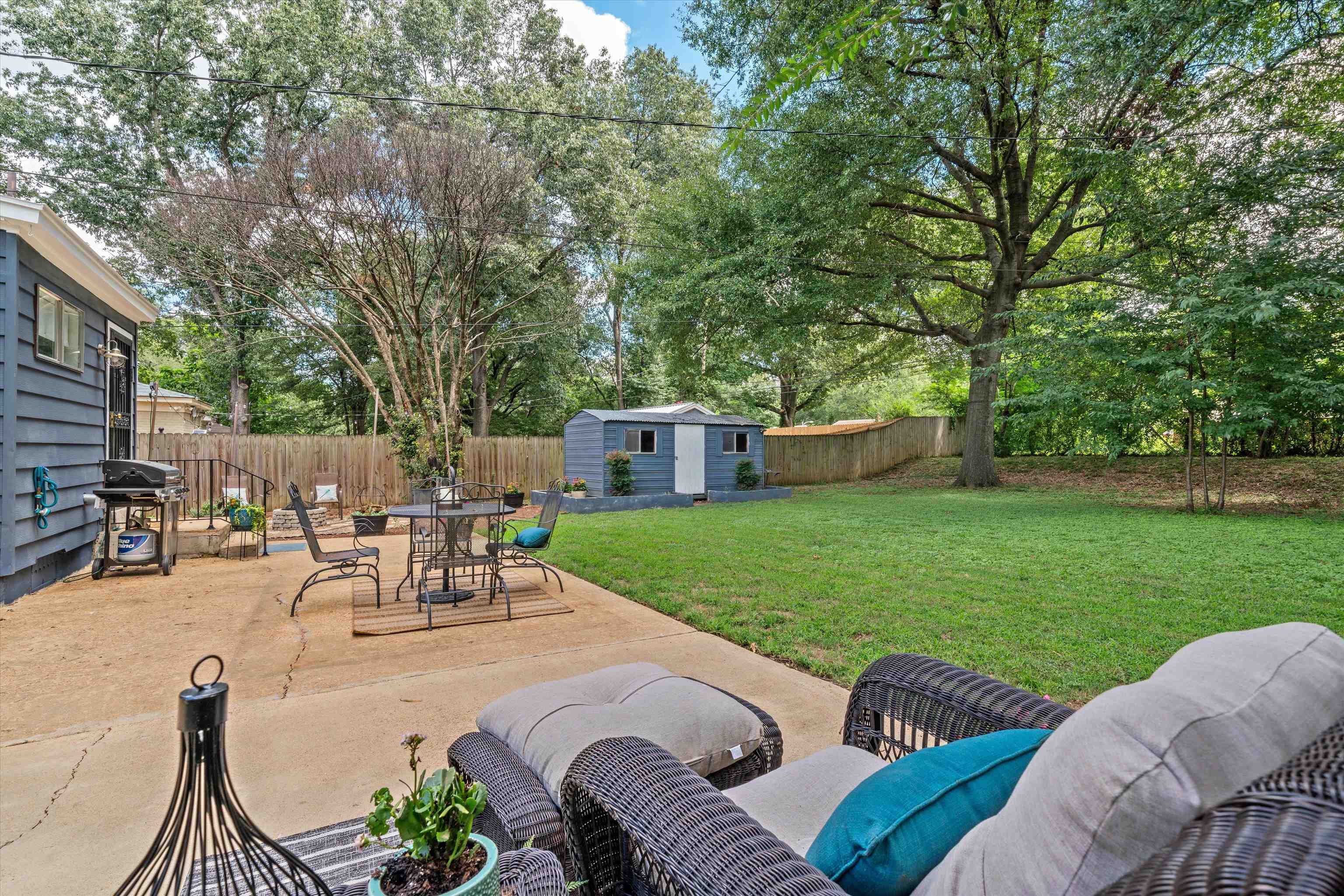 1064 Wilbec Road Memphis, TN 38117 - Photo 21 of 23 a view of a patio with couches table and chairs and a big yard