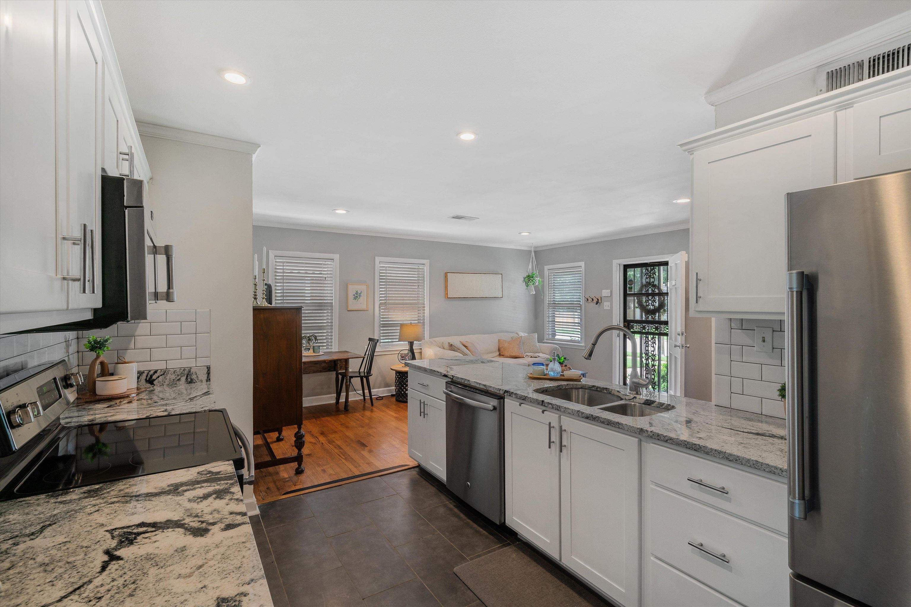 1064 Wilbec Road Memphis, TN 38117 - Photo 8 of 23 a kitchen with stainless steel appliances granite countertop a sink stove and refrigerator