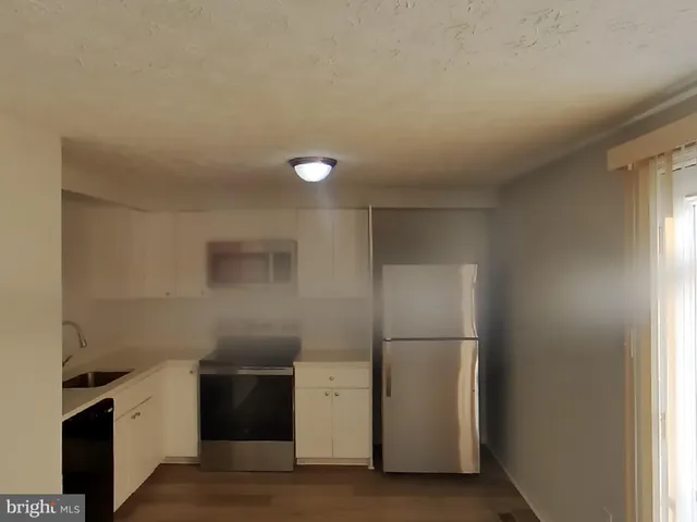 a kitchen with a refrigerator and a stove