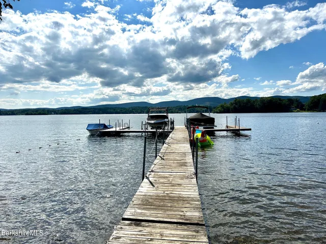 a view of a hallway with wooden floor and stairs